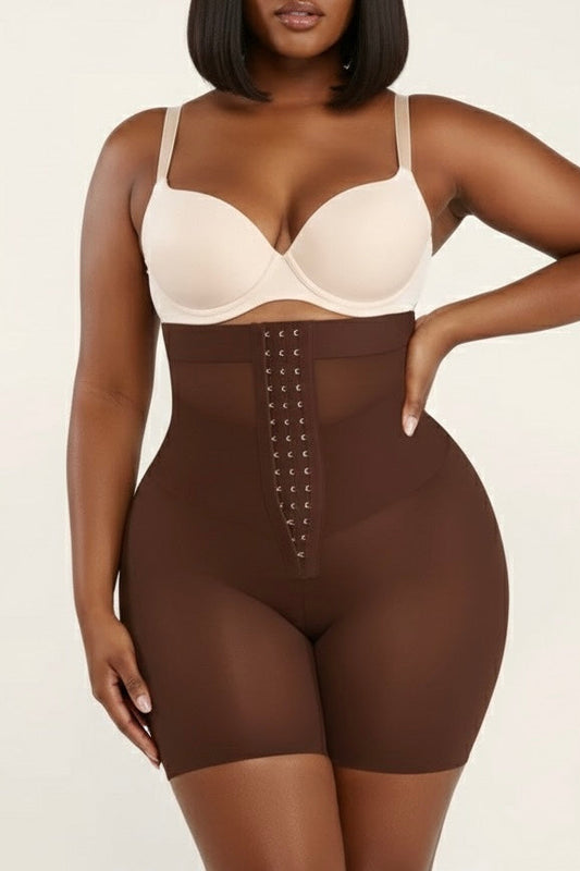 Woman wearing a brown shapewear bodysuit on a beige background