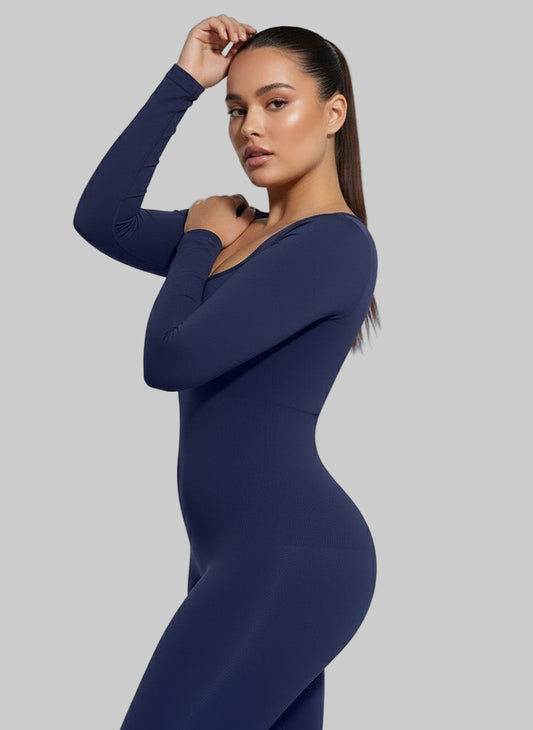 Woman wearing a navy blue long-sleeve bodysuit on a light gray background