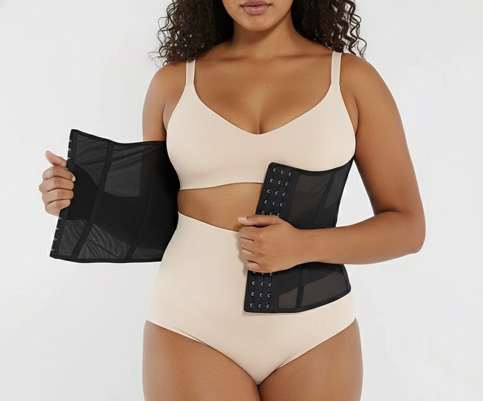 Woman wearing a beige swimsuit holding black mesh panels on a white background