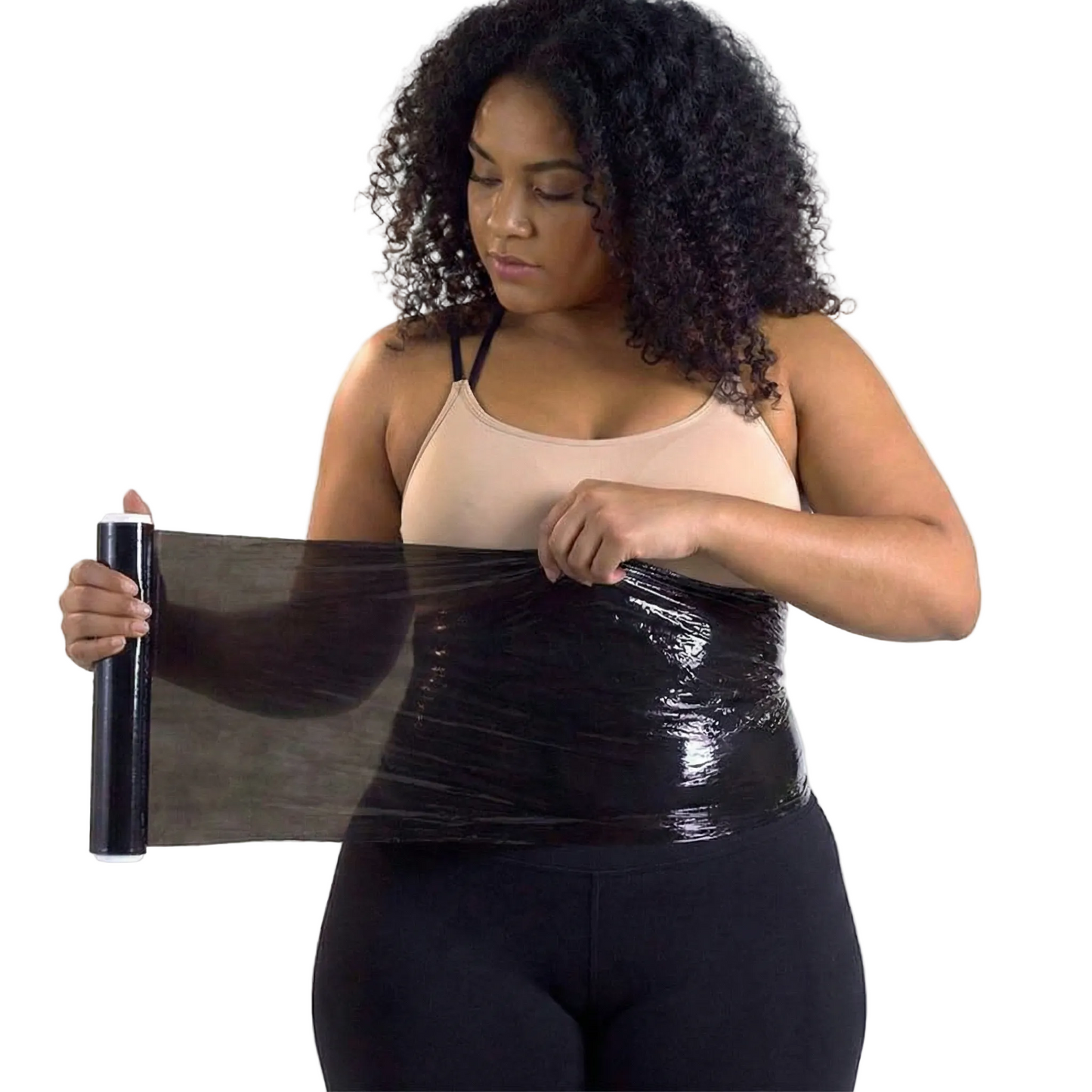 Woman holding a roll of black tape or wrap against a white background